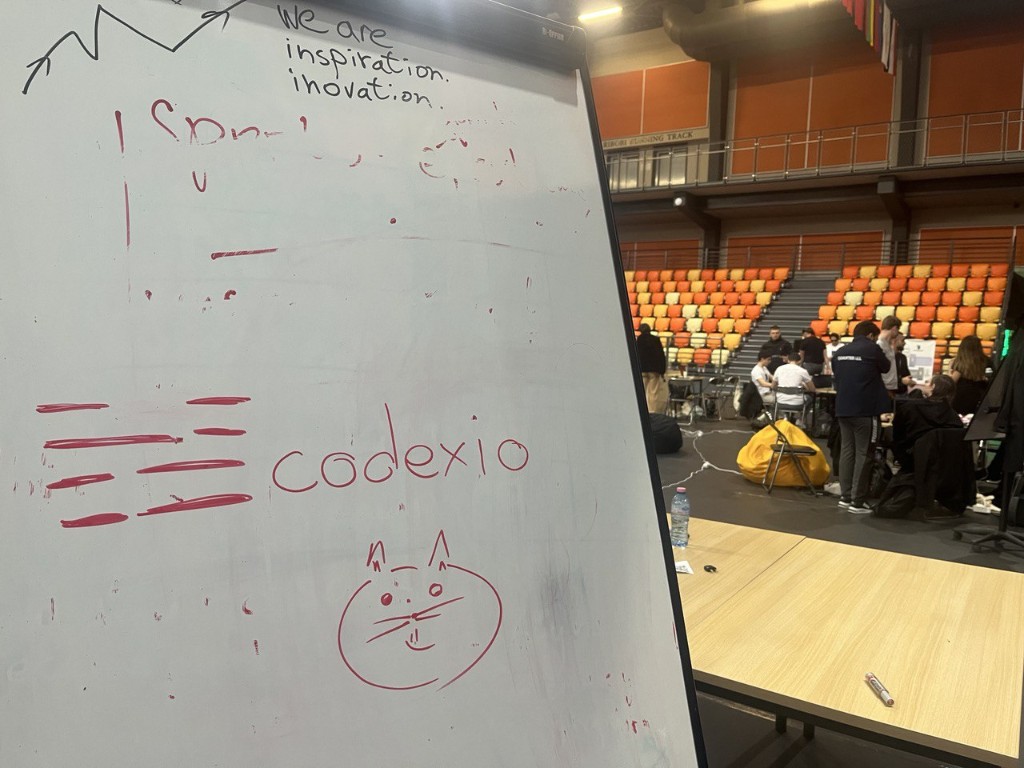 Codexio booth with Codi's cameo on the whiteboard